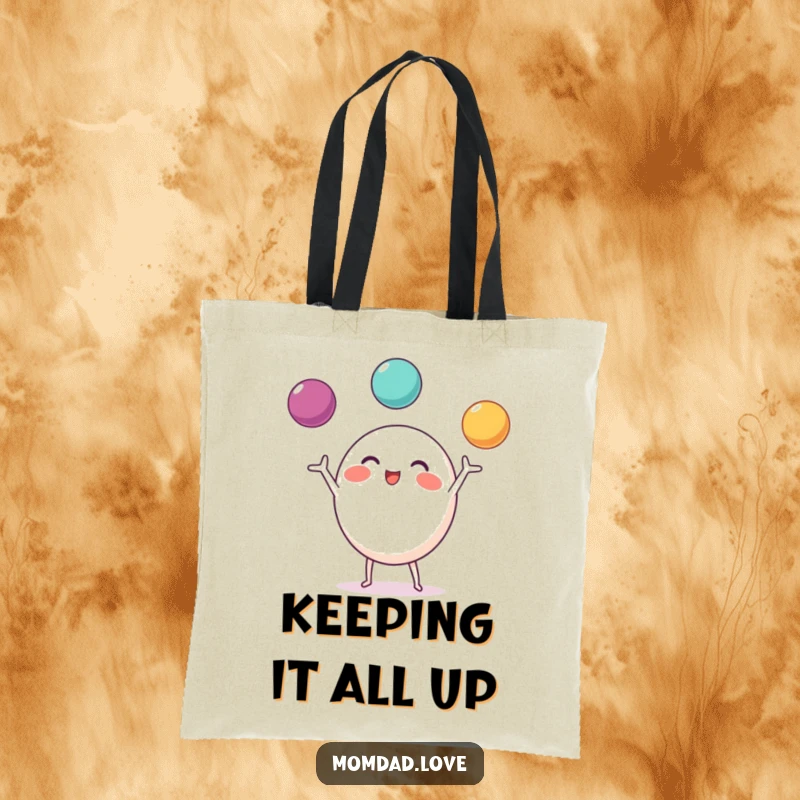 Funny Tote Bag of a round character with little limbs, happily juggling three bright balls.